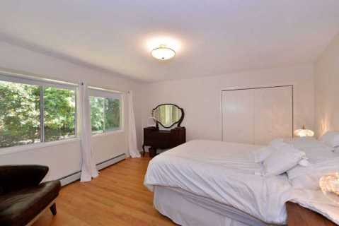 Bedroom with queen size bed located on the main level of the hom