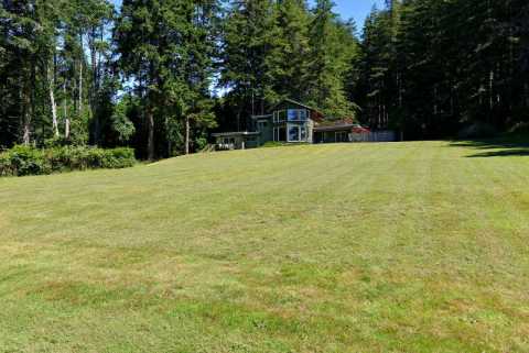 Expansive lawn cascades down to the ocean