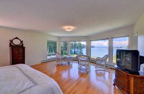Huge master bedroom with views of the ocean and mountains